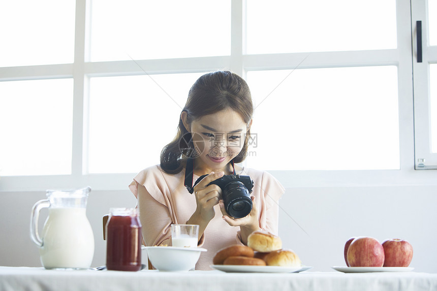 年轻女孩手拿相机记录生活图片