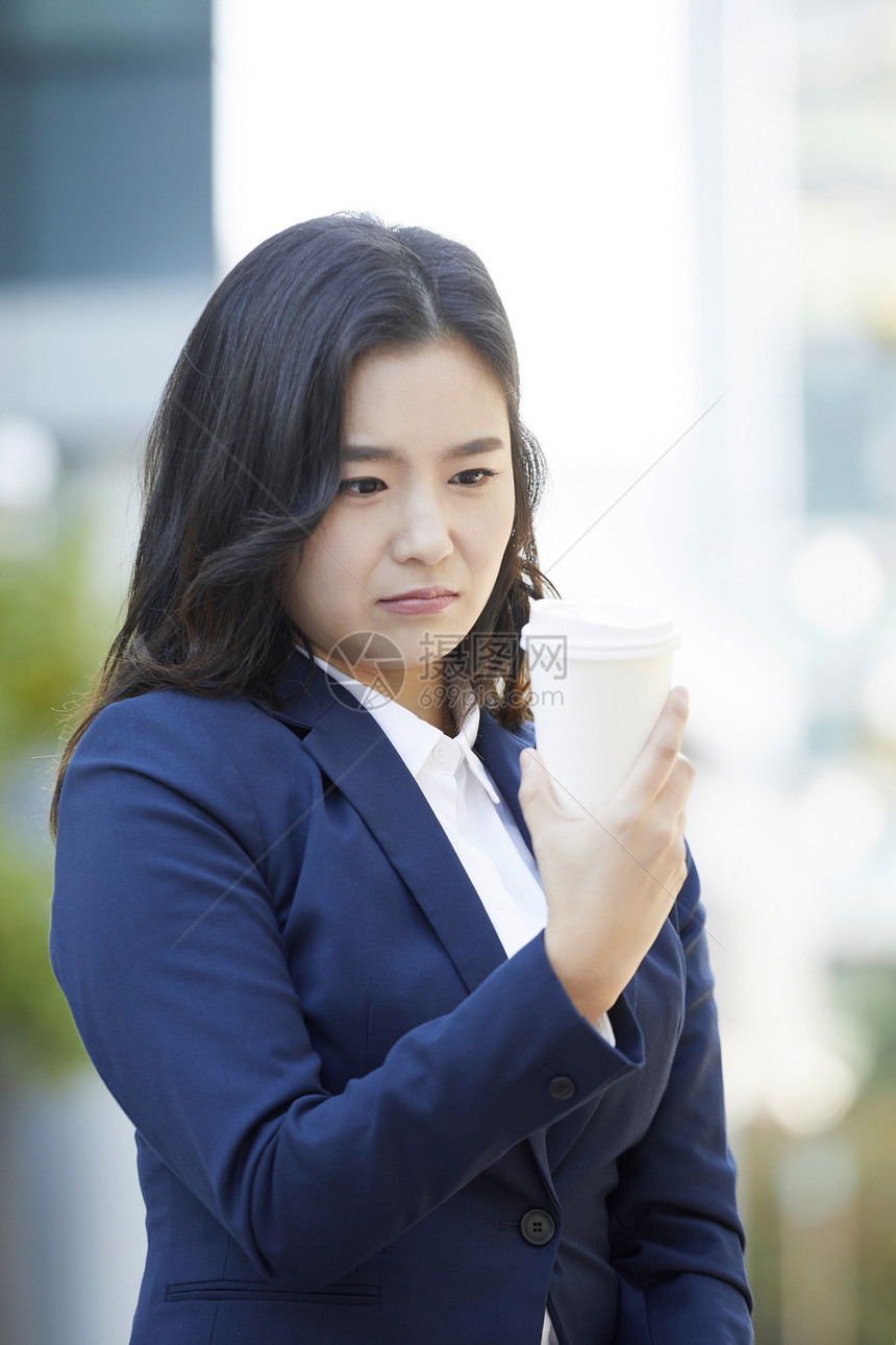 看着咖啡的年轻女子图片