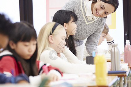 老师在国际学校课堂现场指导学生小孩高清图片素材