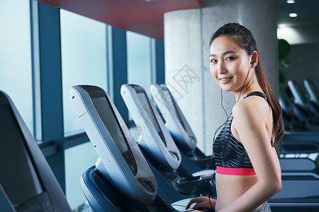 健身房跑步机上的女性图片