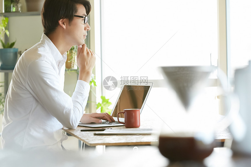 用电脑的男子喝咖啡的时光图片