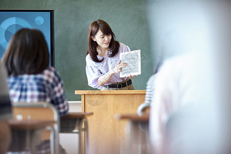 小学生在老师的指导下学习平板电脑使用知识日本人高清图片素材