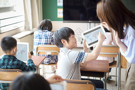 小学生在老师的指导下用电脑查询资料男人高清图片素材