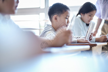 老师在教学生如何使用数码产品学习背景图片