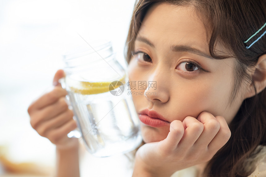 居家拿着柠檬水的青年女子图片