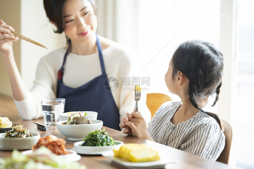 餐桌上用餐的母女图片