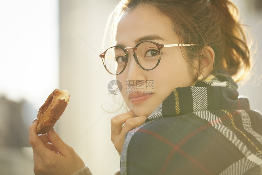 拿着面包的年轻女子图片