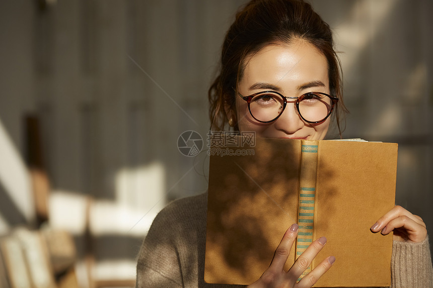 拿着书微笑的文艺女青年图片