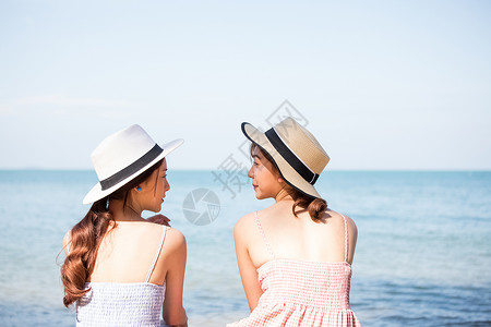 坐在海边的年轻女子背影图片