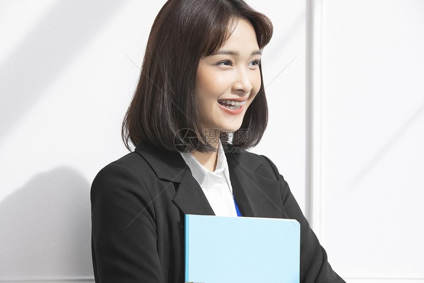 商业女性抱着文件夹微笑图片