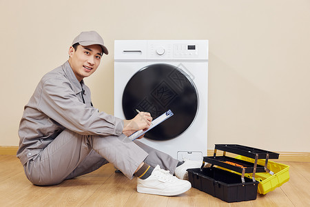 男性维修工人检修滚筒洗衣机电器维修高清图片素材