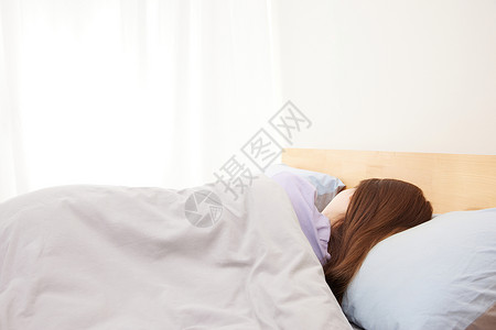 阳光起床躺在床上睡觉的女性背影背景