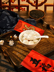 拿红包汤圆中式元宵节传统芝麻汤圆背景