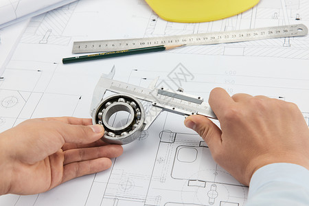 轴承素材使用工程制图工具的建造师手部特写背景