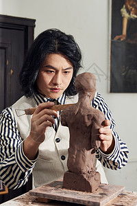 文艺男青年雕刻泥塑作品图片