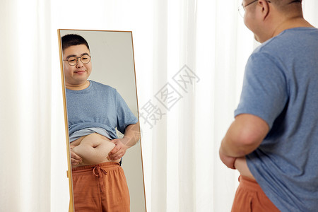 胖男生镜子前看肚子上的赘肉图片