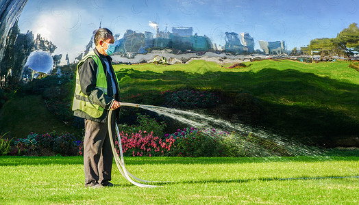 公园清洁工城市绿化带环卫工洒水背景