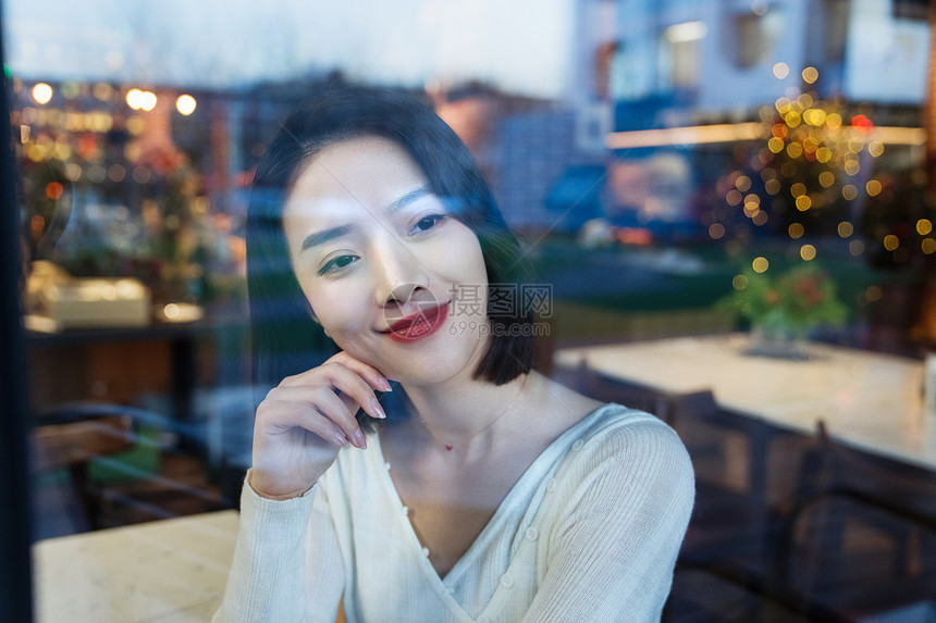 优雅的年轻女人看向窗外图片