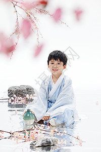 桃花树下的古风小男孩形象背景图片