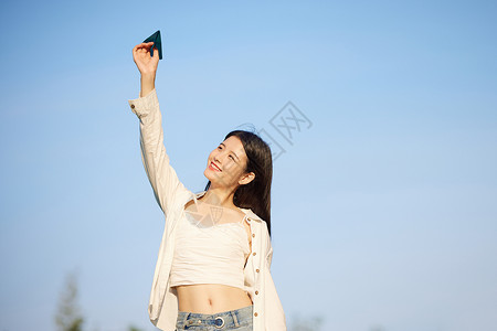 小清新纸飞机手举纸飞机的美女背景