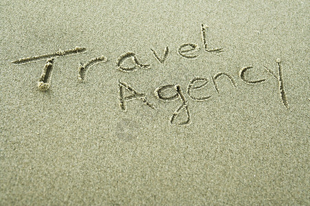 对旅行社或旅行业有用手写成的沙图片