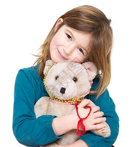 贴近一个可爱女孩的肖像带着泰迪熊与世隔图片