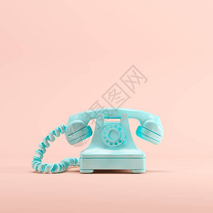 用粉色糊面彩色背景的蓝色古老电话图片