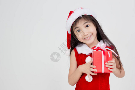 穿着红圣诞老人礼服的快乐的小亚图片