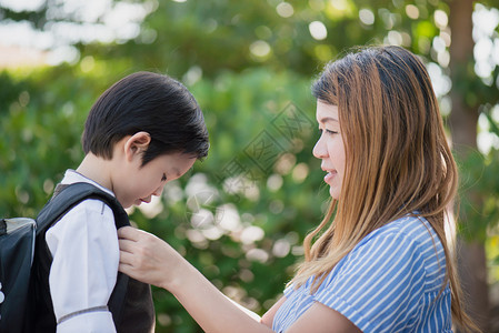 亚裔母亲在儿子离开上学时向儿子告别回图片