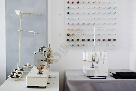空裁缝制工作室和配有缝纫机和缝纫机的桌图片