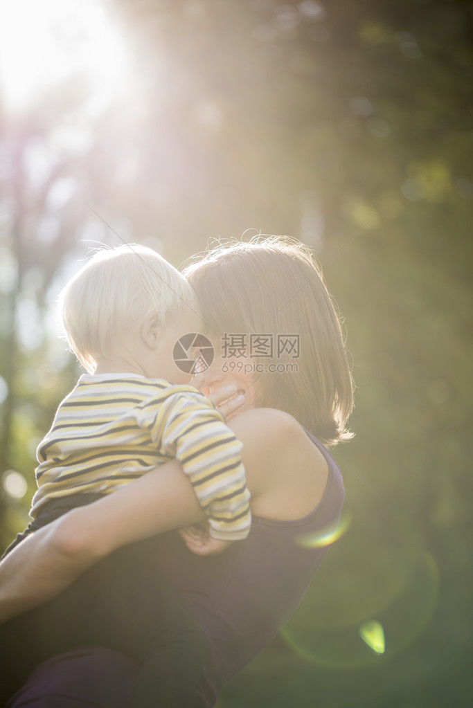 一个年轻母亲和她的儿子之间美丽的爱时刻当他们凝视着对方的眼睛被自然界外的阳图片