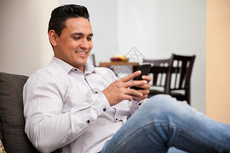 快乐的年轻人社交网络和在家用智能手机发短信图片
