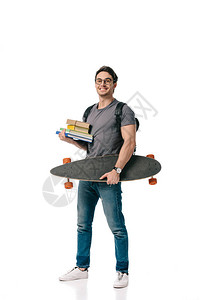微笑英俊的学生拿着书和滑板被白色隔离图片