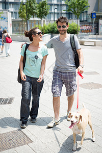 夫妻俩早上在街上遛狗背景图片