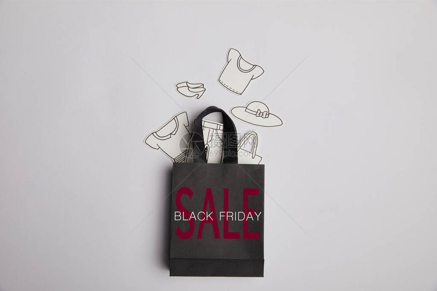 黑纸袋黑色星期五销售品和灰色底面的纸衣图片