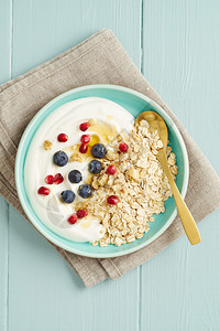 早餐燕麦面加蓝莓石榴种子坚果蜂蜜和酸奶图片