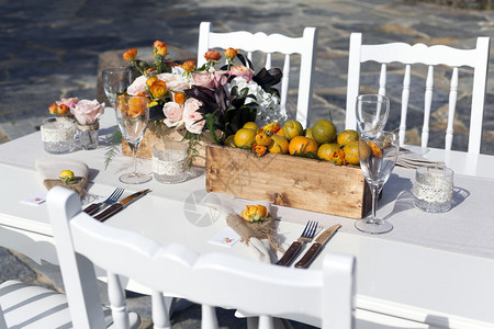 户外白色餐桌上摆放的鲜花和餐具图片