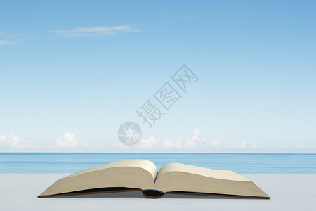 海街日记在户外桌子上开业的书与海和蓝天空设计图片