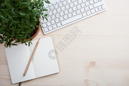 风格化的桌面潮人工作区白色电脑键盘和办公物品带复印空间的图片