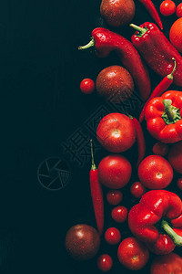 灰色深桌子上红番茄甜椒和辣椒的顶视图图片