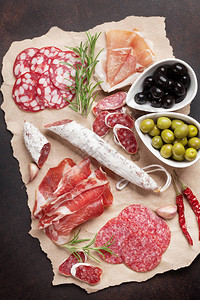 意大利腊肠切片火腿香肠熏火腿培根橄榄石桌上的肉开胃菜顶视图图片