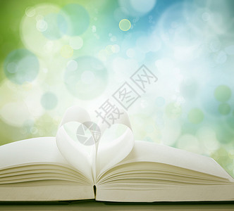 蓝绿色背景面前的爱情心形书刊页数以爱背景图片