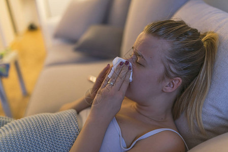 发烧躺着表情包家里受流感困扰的年轻女在发烧时抽鼻背景