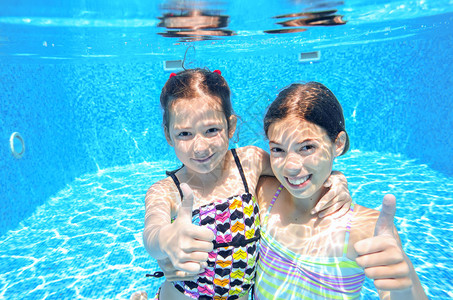 快乐的孩子们在水下游泳池游泳图片