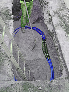 地下安装大型电缆手持铲子的工人在地图片
