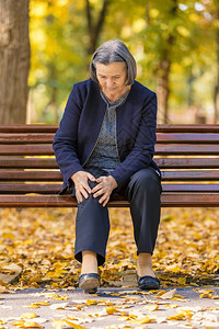 老年女子在秋天公园散步图片
