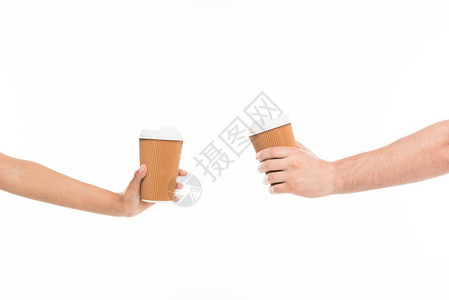 近距离收成的两只手握着可支配杯子在背景图片