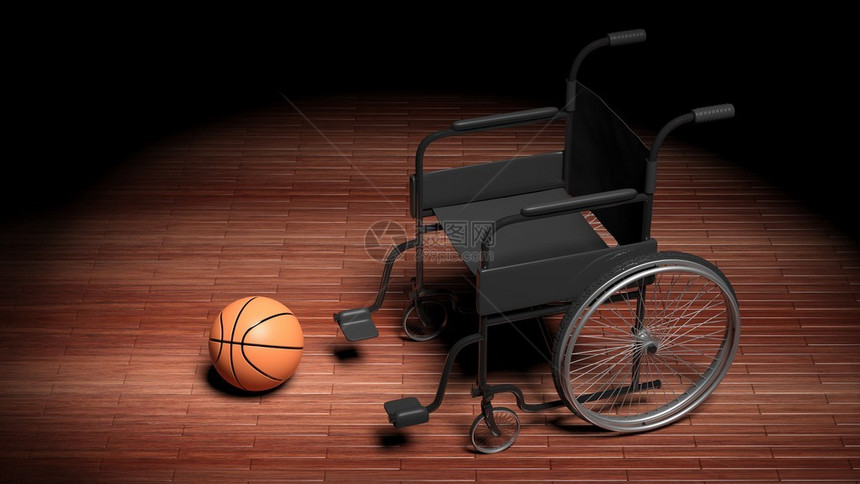 木制镶木地板上带篮球的轮椅图片