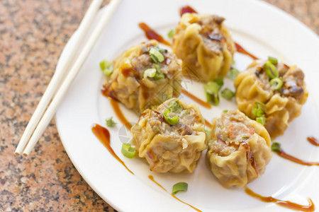 美味的中式点心饺子配上葱和甜酱图片
