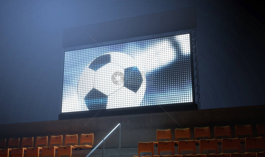 夜间在看台上显示足球重播的照明体育场大屏幕